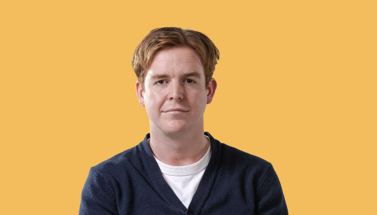 man in blue sweater with red hair